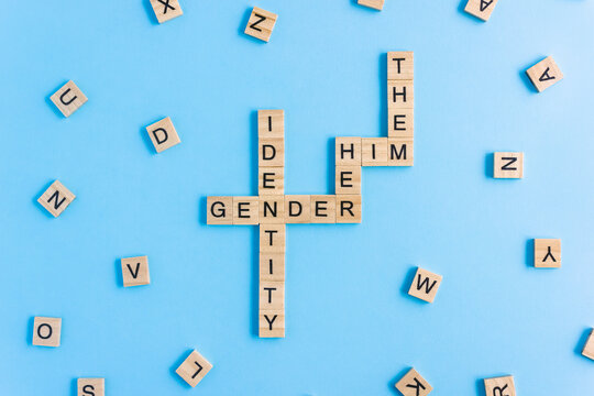 Words Gender Identity and His, Her and Them made up of wooden blocks with letters. Pronouns gender concept.