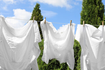 Clean clothes hanging on washing line outdoors. Drying laundry