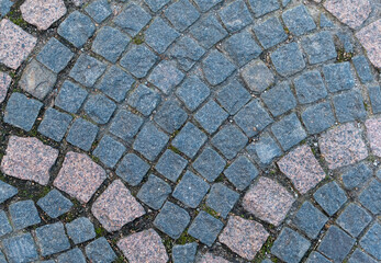 Bicolor stone cobblestone granite of walking street. View from above
