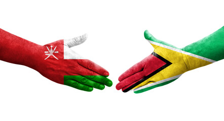 Handshake between Guyana and Oman flags painted on hands, isolated transparent image.