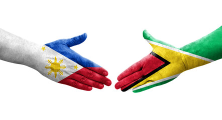 Handshake between Guyana and Philippines flags painted on hands, isolated transparent image.