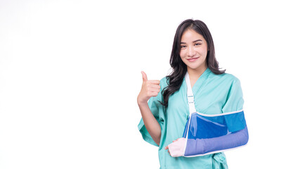 Injury asian woman wear patient broken arm hand splint showing thumbs up for good service health...