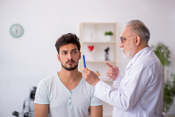 Young male patient visiting old male doctor