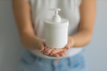 The girl holds in her hands a bottle of gel for intimate hygiene. Women Health. Soft focus