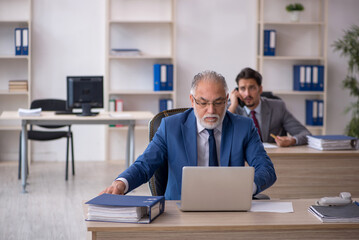 Two male colleagues working in the office