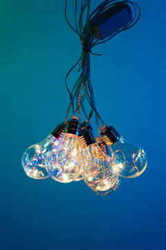 Knotted light bulbs on soft light background, wallpaper with lights detailed view