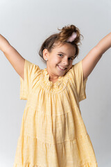 Fototapeta premium Stylish girl in yellow dress on white background with a genuine smile