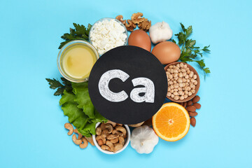 Food high in calcium. Flat lay composition with different products on light blue background - obrazy, fototapety, plakaty