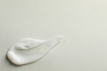 Sample of face mask on light background, top view. Space for text