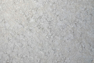 Detail of a dry and cracked desert floor surface in a former lakebed is shown in a closeup view.