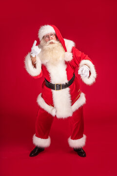 Merry Christmas and Happy New Year! Photo of funny Santa Claus with white beard looking at the camera, dancing. Xmas sale, discount concept.