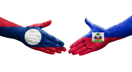 Handshake between Haiti and Laos flags painted on hands, isolated transparent image.