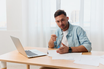 Fototapeta premium Happy enthusiastic smiling nice-looking young businessman show point finger at camera in office communicates with candidate. Copy space for ad. Remote Job, Technology And Career Profession Concept