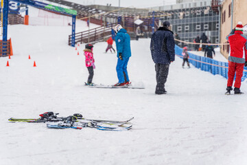 Winter, ski slope. Alpine skiing in snow against background of blurred exercising children with instructors