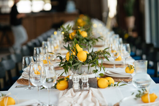 Festive table at the wedding party decorated with lemon arrangements