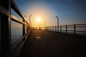 Naklejka na ściany i meble Picturesque view of empty pier at sunrise