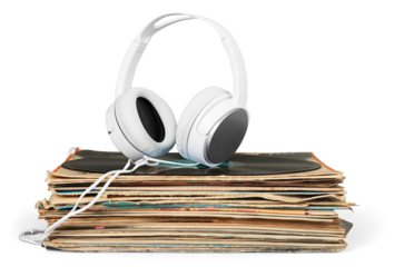 Golden headphones lying on the stack of vinyle records