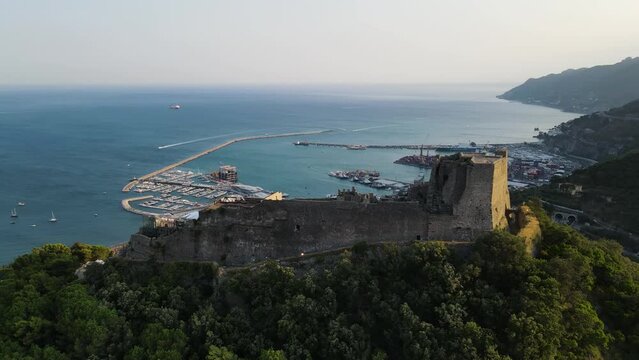 Aerial view of Arechi castle on hilltop with Mediterranean Sea in background during sunset, Salerno, Italy.