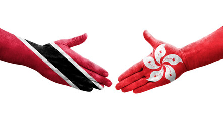 Obraz premium Handshake between Hong Kong and Trinidad Tobago flags painted on hands, isolated transparent image.