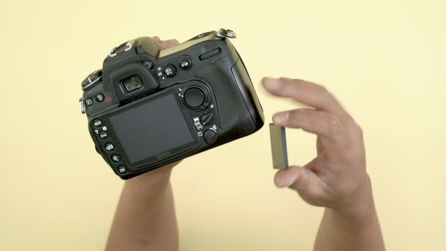 close up footage professional photographer film maker ejecting memory cf card form dslr camera with copy space
