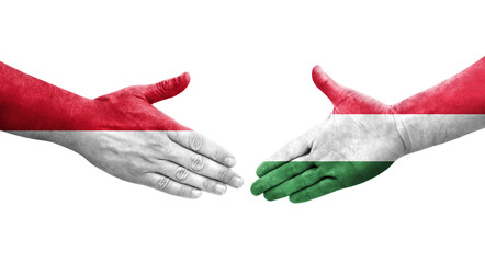 Handshake between Hungary and Monaco flags painted on hands, isolated transparent image.