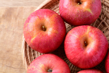 Red apple fruit in basket on wooden background, Healthy fruit