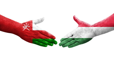 Handshake between Hungary and Oman flags painted on hands, isolated transparent image.