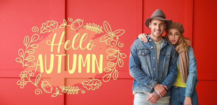 Happy young couple in warm clothes and text HELLO AUTUMN on red background - Powered by Adobe