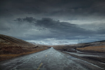 Snowy mountain road in cloudy weather.