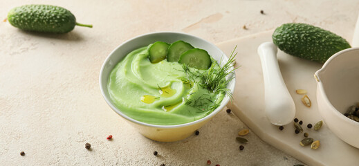 Bowl with cold cucumber soup gazpacho on light background
