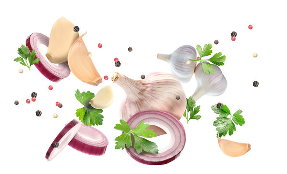 Flying garlic, onion, parsley and peppercorn isolated on white