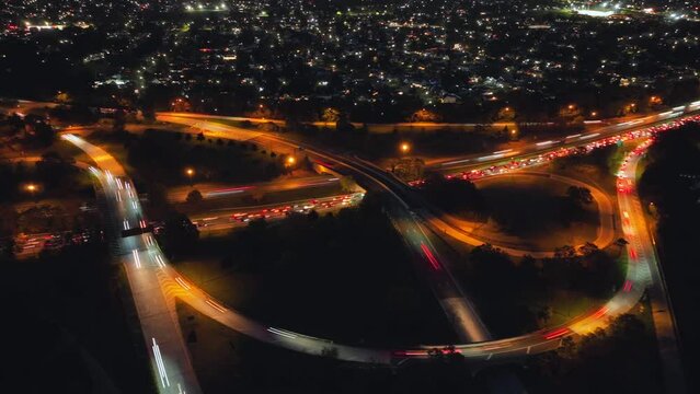 And aerial time lapse of a major highway intersection on Long Island, NY with lots of curved exits and entrance ramps. The camera truck right and pan left, orbiting the busy intersection.