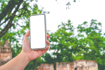Close up women using a smartphone with empty white screen at the outdoor.