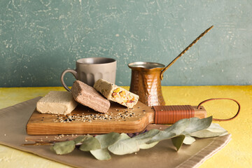 Wooden board of tasty sesame halva on table
