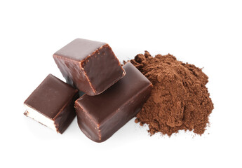 Tasty bird's milk candies and heap of cocoa powder on white background