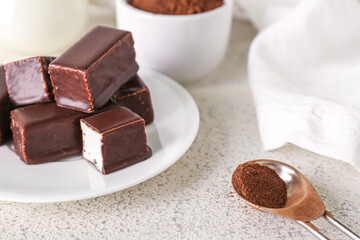 Plate with tasty bird's milk candies on light background, closeup