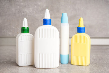 Bottles of glue on grunge background