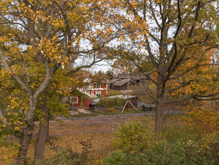 Old preserved houses in a park a colorful sunny autumn day in Stockholm