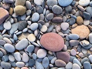 pebbles on the beach in many colors