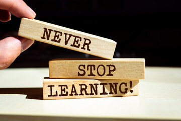 Wooden blocks with words 'Never Stop Learning'.