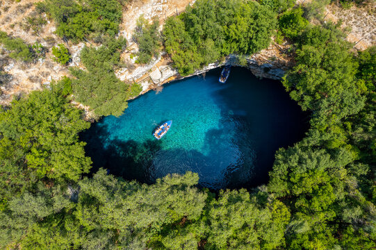 Aerial view of the  iconic Melissani cave with the crystal clear  turquoise waters located near port of Sami, Kefalonia island, Ionian, Greece