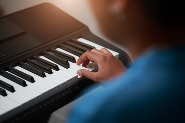 Close-up of male hands playing keyboard