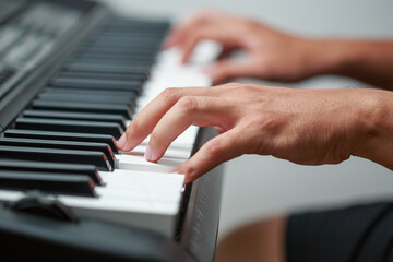 Fototapeta na wymiar Close-up of male hands playing keyboard