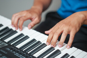 Close-up of male hands playing keyboard