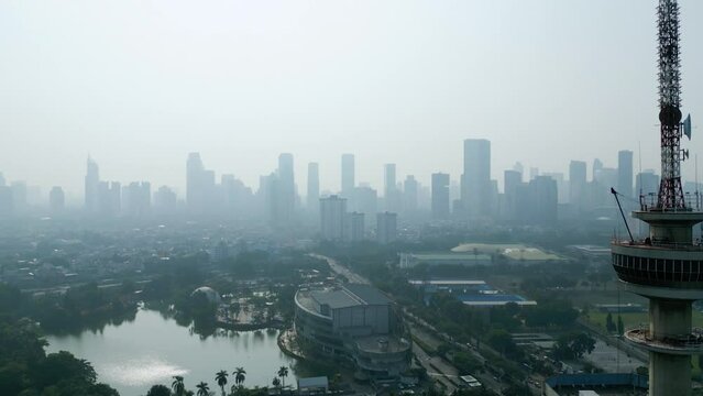TVRI tower with misty Jakarta cityscape