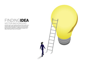 Silhouette of businessman walking to ladder to light bulb . Business Concept of creative idea and solution.