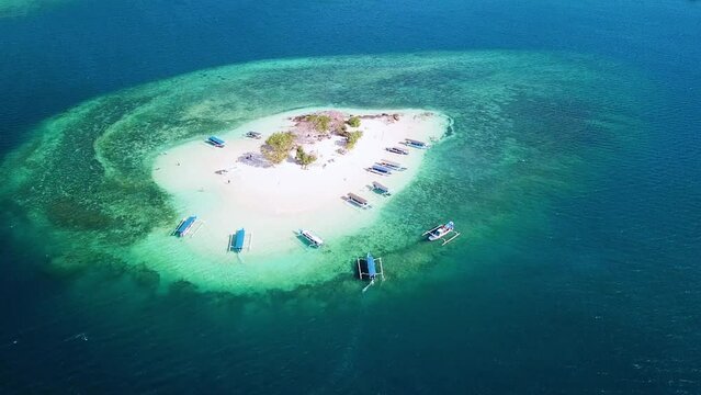 Aerial view of Gili Kedis island with travel boats