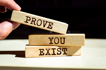 Wooden blocks with words 'Prove you Exist'.
