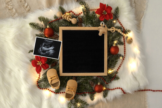 Letter board Baby Announcement . Baby Clothing Mock Up . Space for design . Pregnancy announcement background with blurred . Selective focus