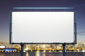 Blank white horizontal billboard on cityscape background at night, front view. Mockup, advertising concept